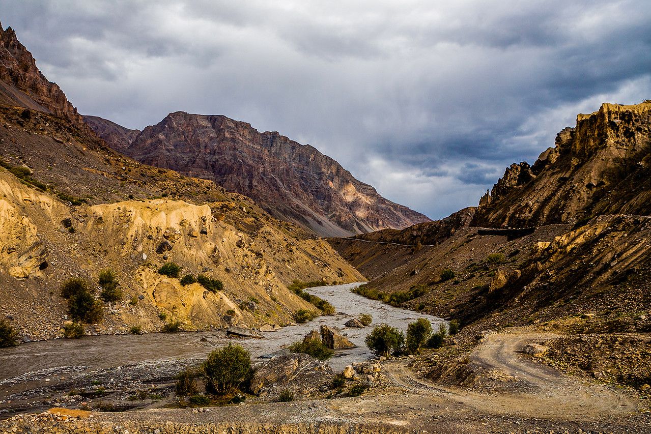 river flowing between two brown mountains near kaza