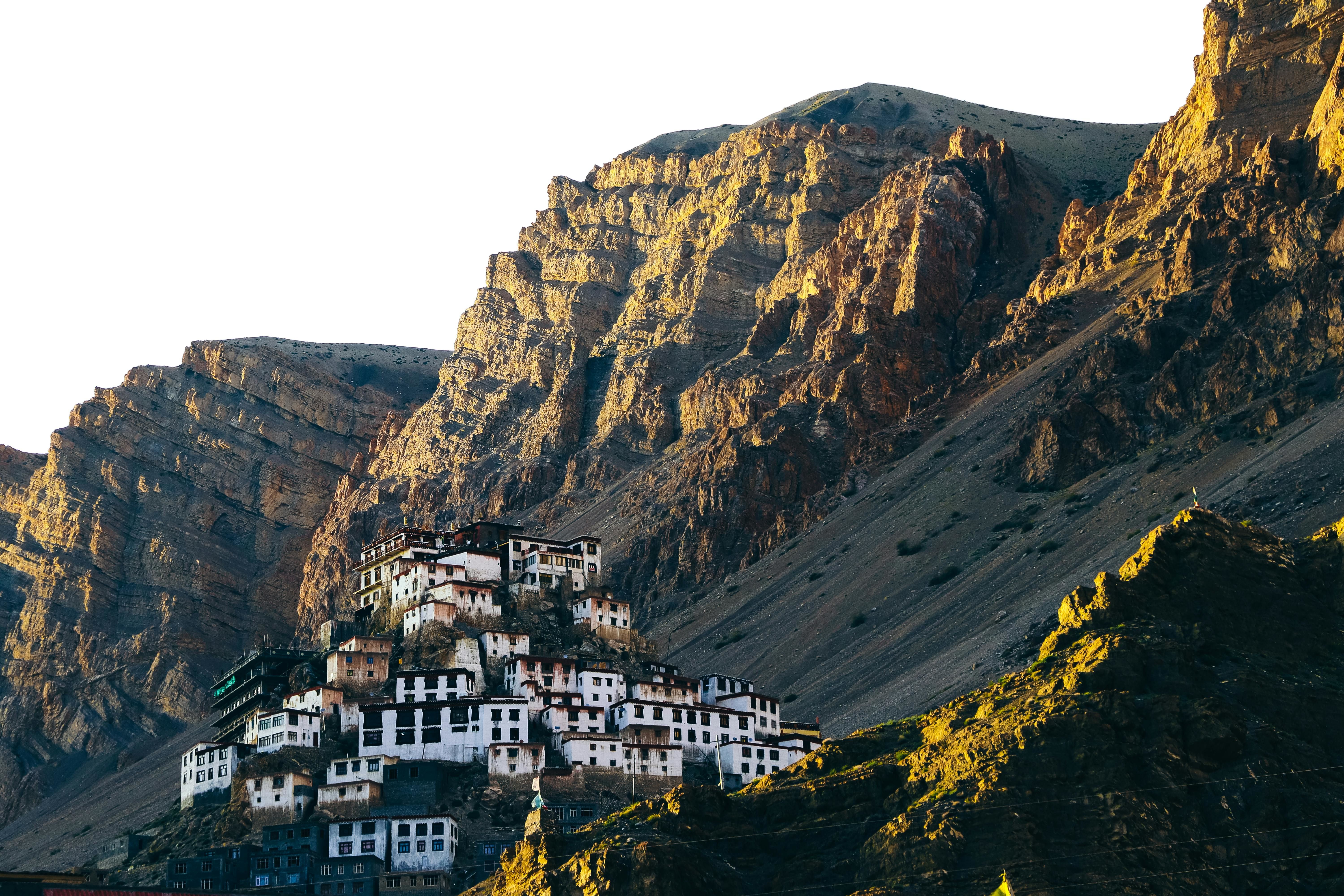 key monastery surrounded by brown mountains during evening