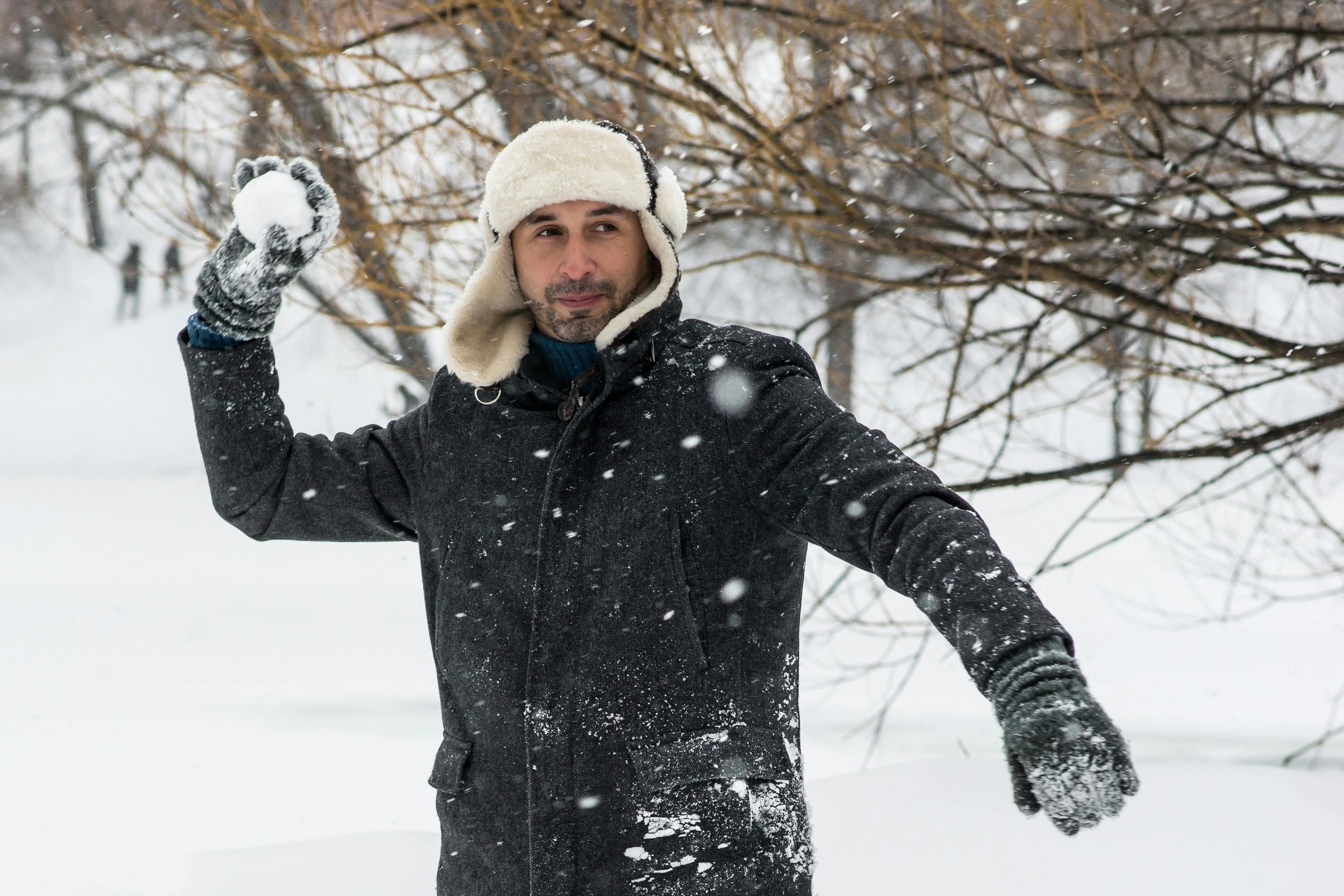 a man holding snowball