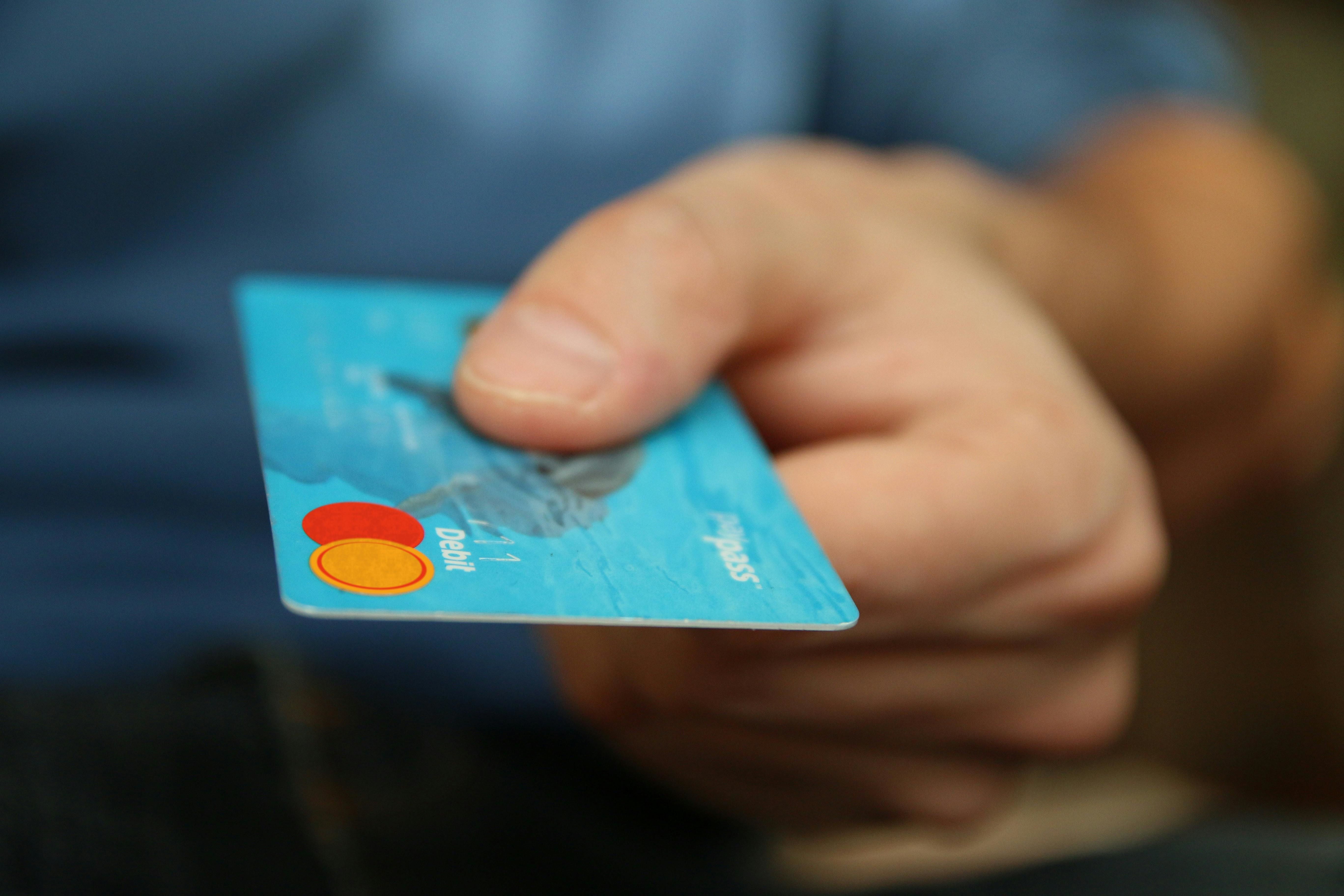 a person holding a debit card