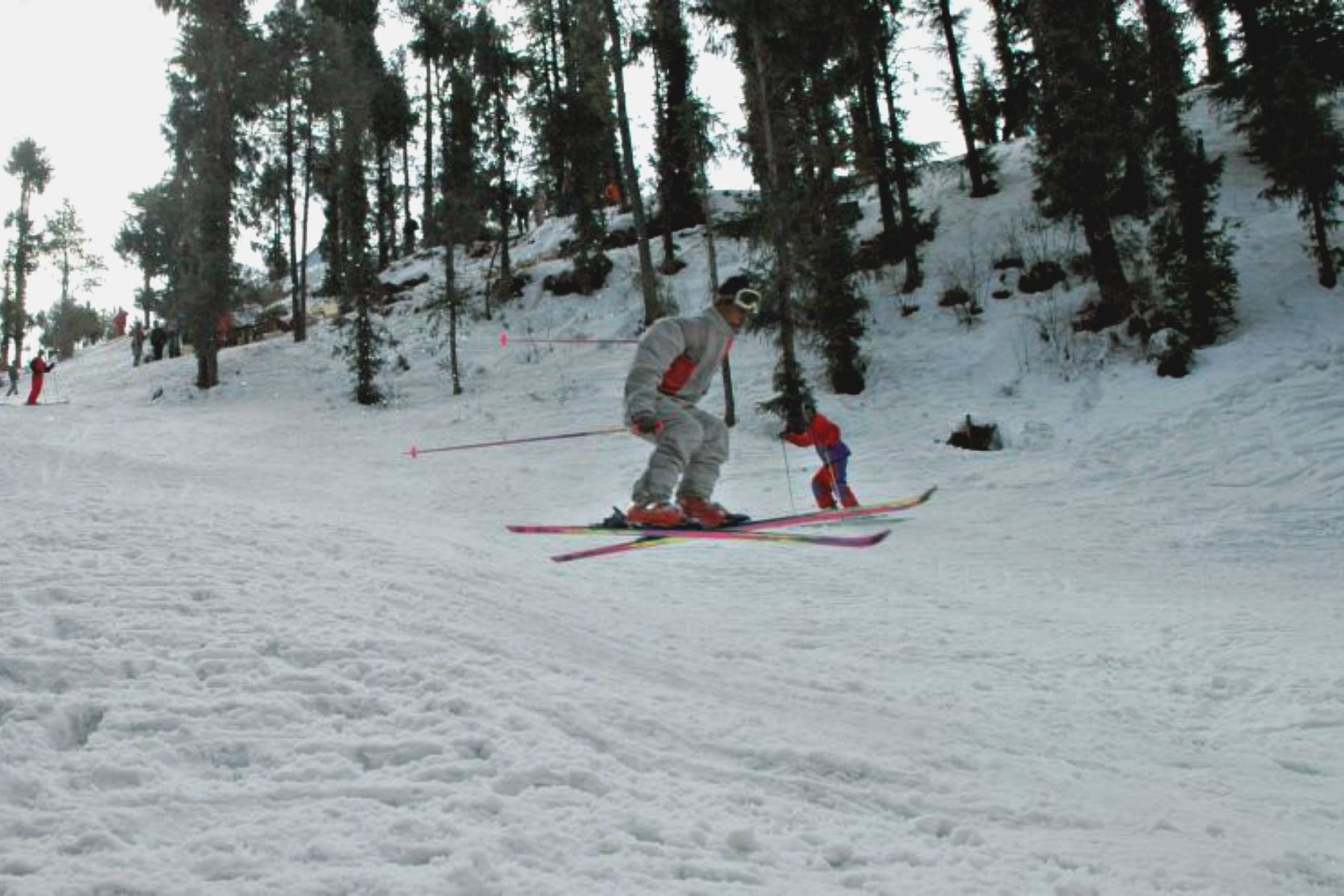 a person skiing over snow in kufri